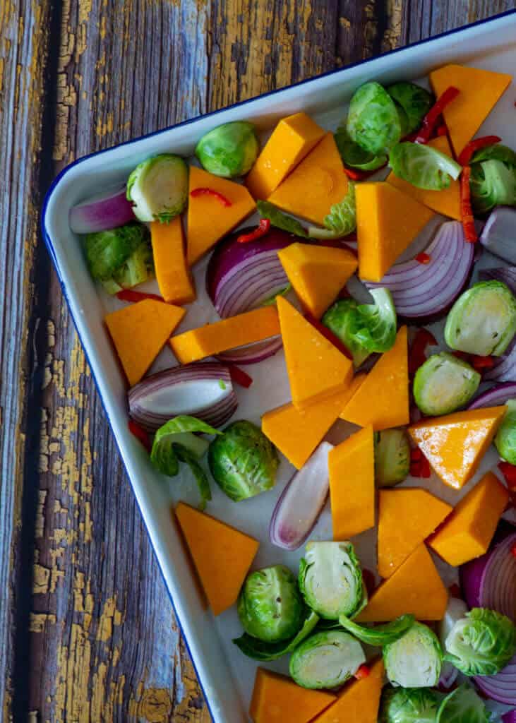 raw vegetables on a roasting tray