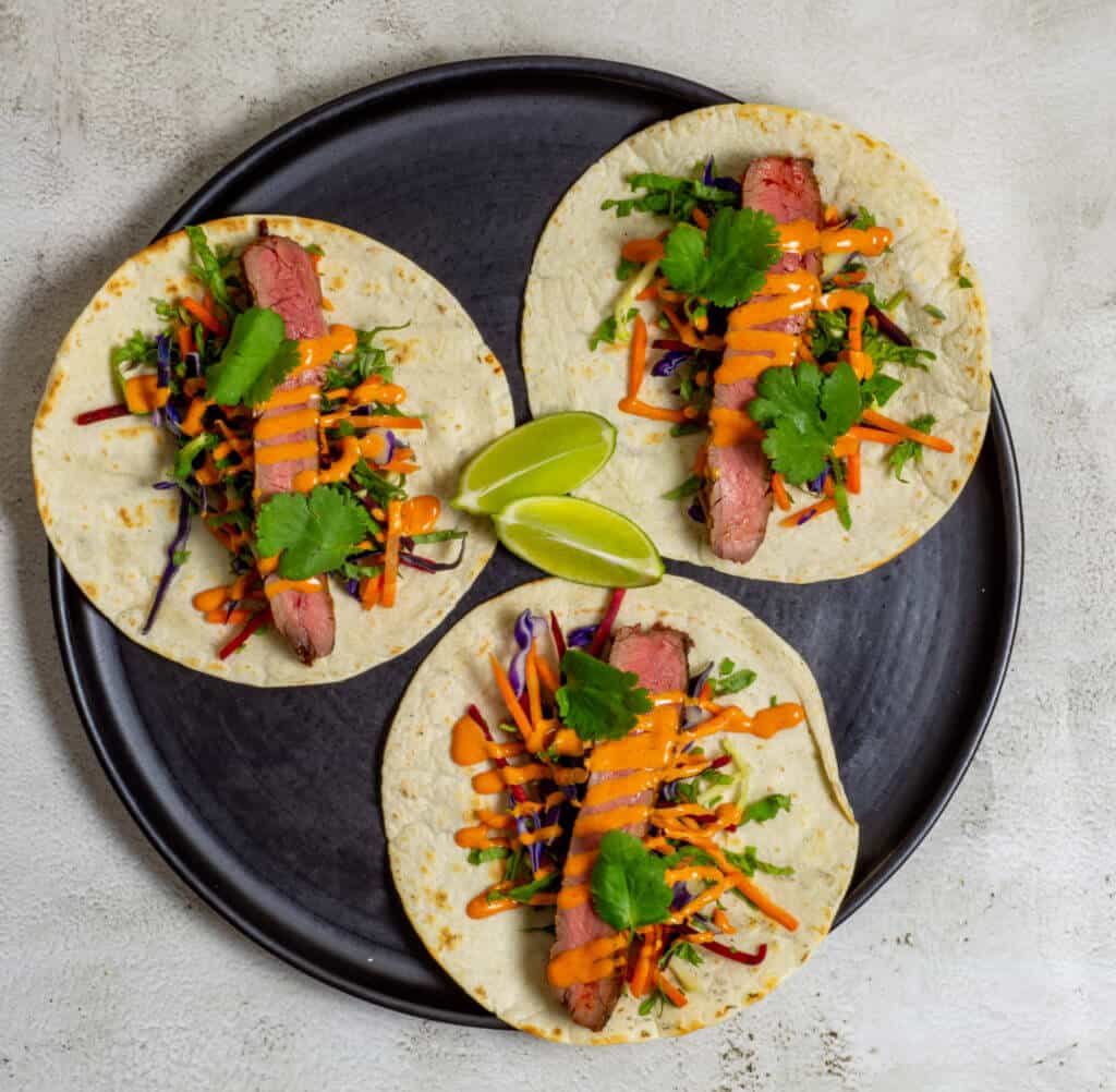 3 steak tacos on a plate