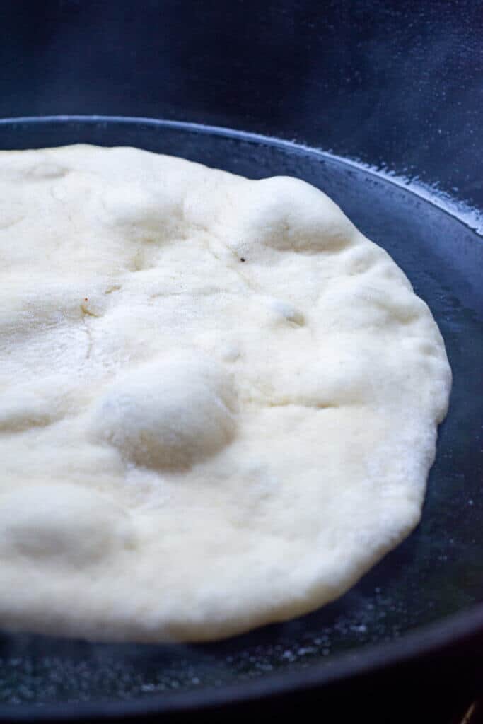 pita cooking in a cast iron skillet