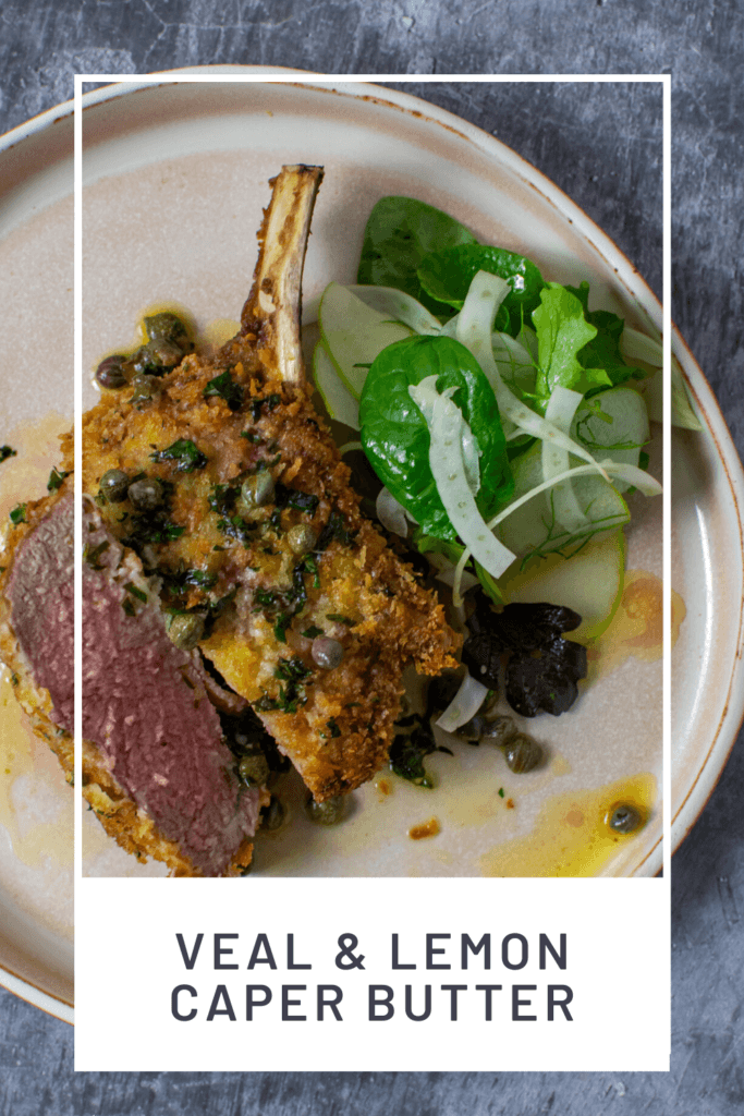 crumbed veal cutlet sliced in half with lemon caper sauce and salad