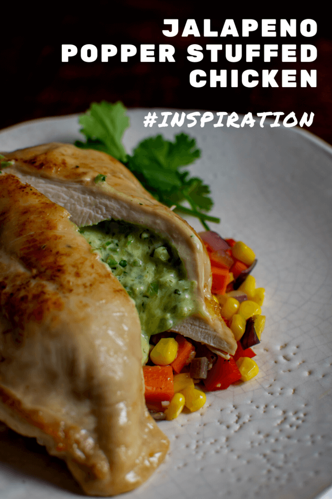 jalapeno popper stuffed chicken on white plate with corn hash