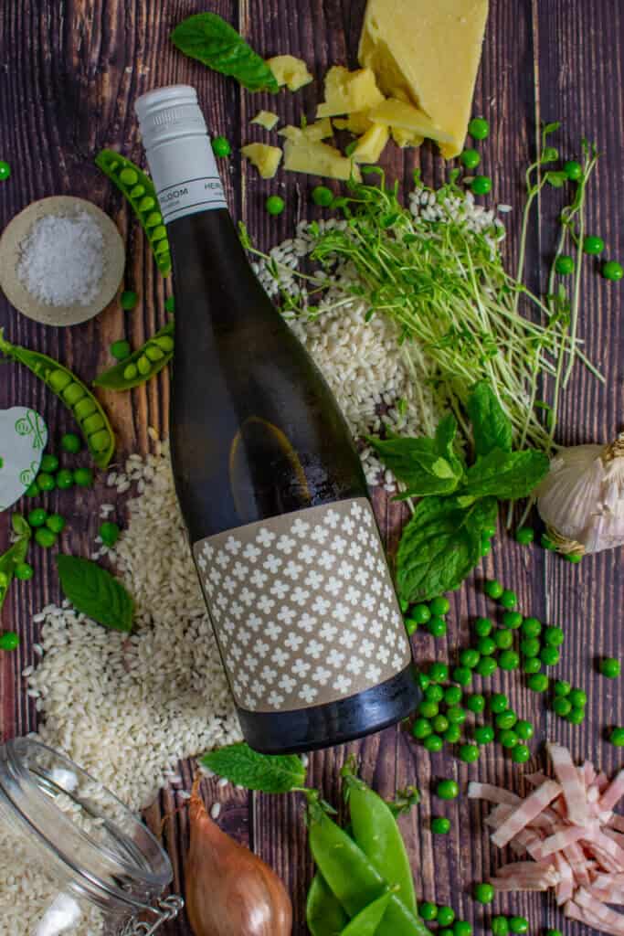 heirloom chardonnay, arborio rice & pea risotto ingredients on wooden table