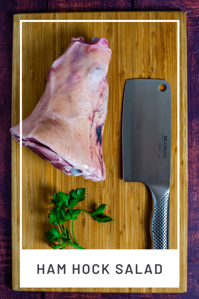 ham hock & a global meat cleaver on a chopping board