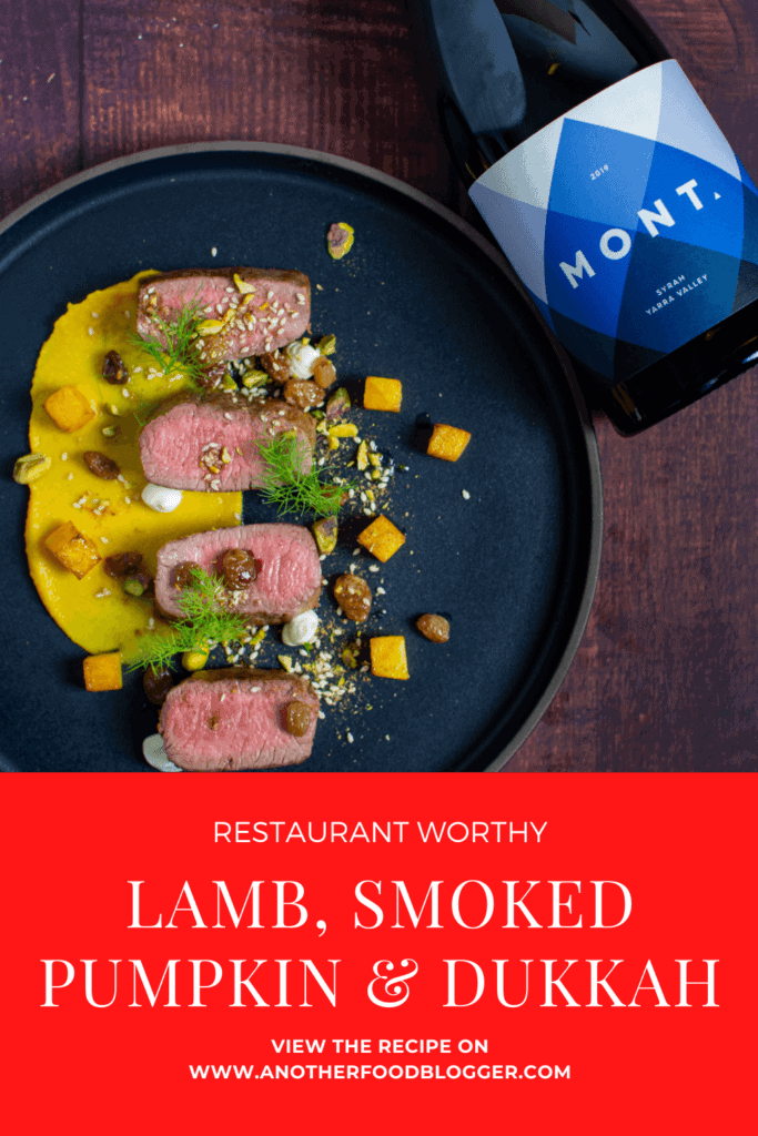 lamb, smoked squash puree, & pistachio dukkah on a black plate with mont wines syrah next to it