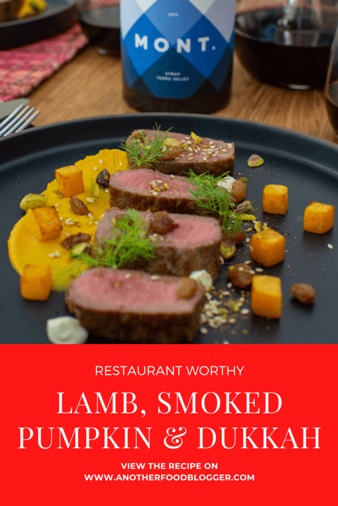 lamb, smoked squash puree, & pistachio dukkah on a black plate with mont wines syrah & wine glasses next to it