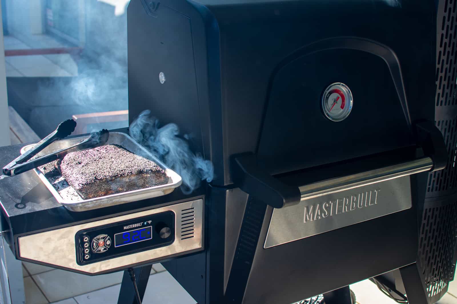 masterbuilt barbecue smoking with beef short ribs next to it