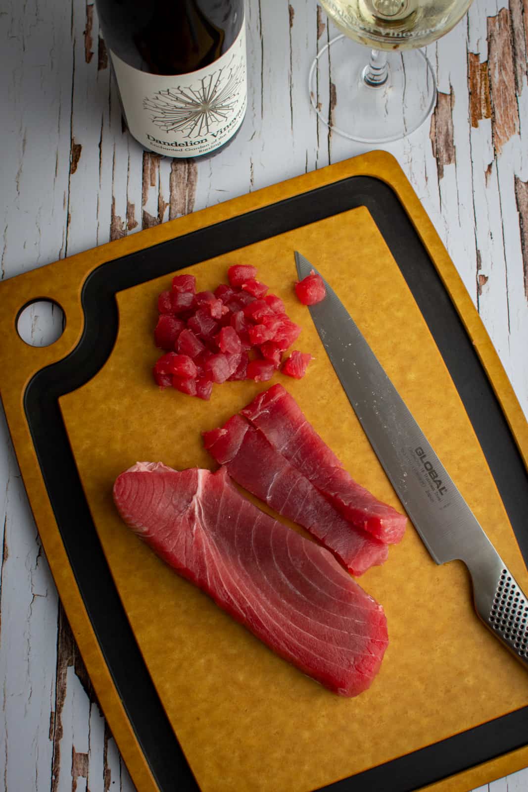 Sliced raw tuna on a chopping board 