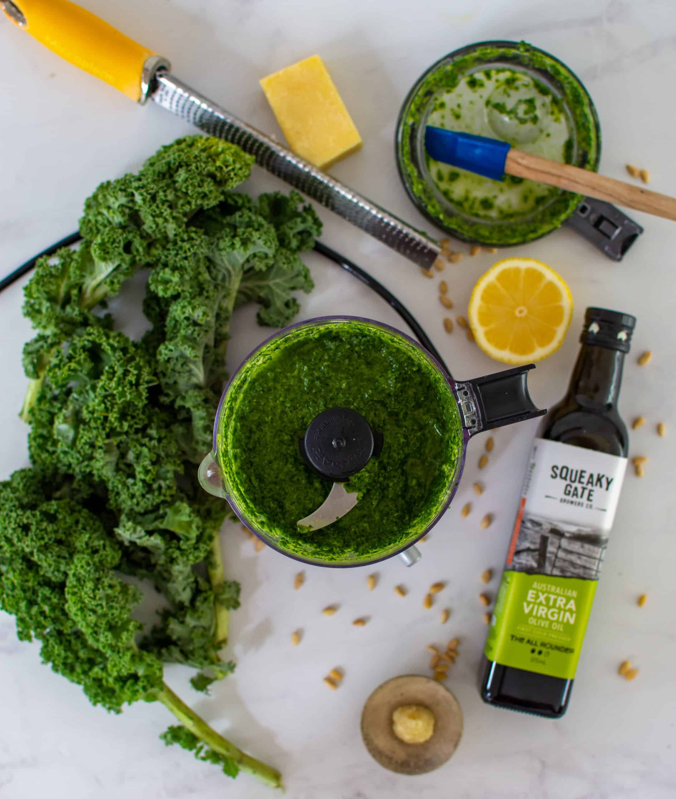 birdseye view of kale pesto in a blender with ingredients 