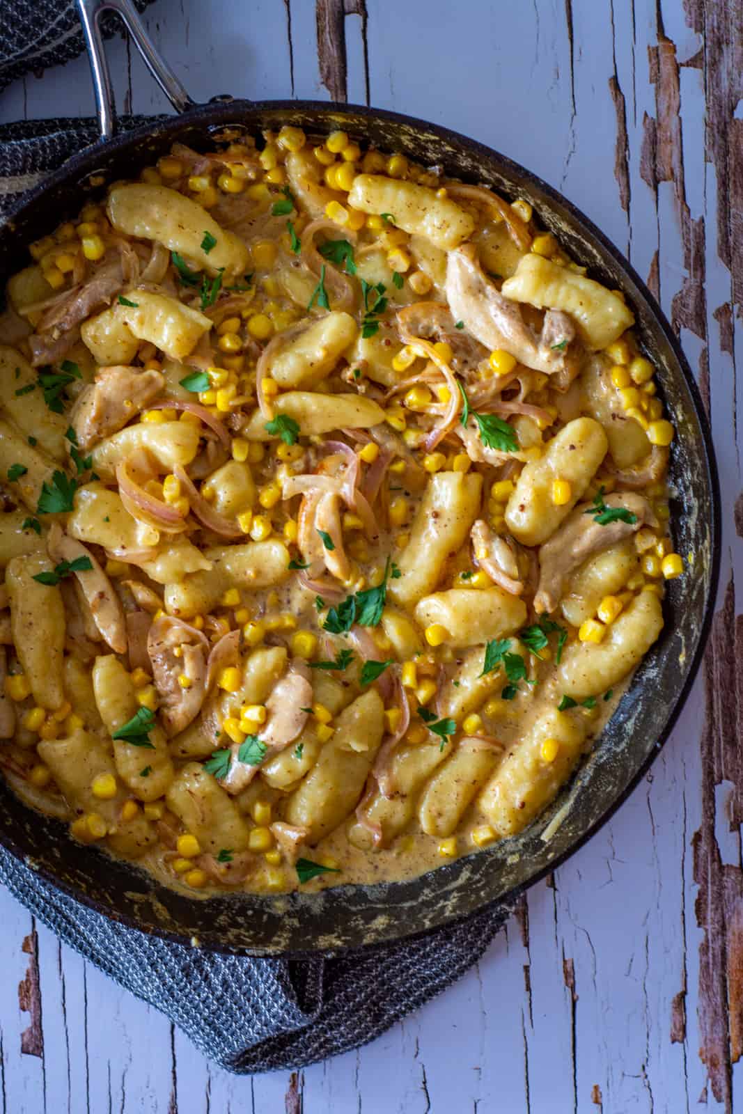 creamy chicken and corn gnocchi in a pan on the table 